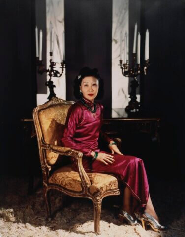 Madame Koo wearing a "body-hugging 1930's qipao" with a side slit